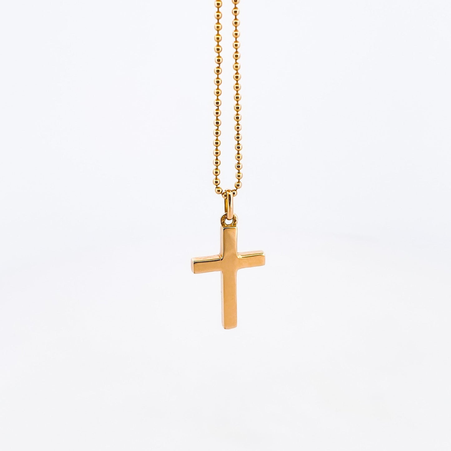 Comprar colgante en oro amarillo de 18kt en forma de cruz y acabado liso. Joyería Ian'Or. Joyas de segunda mano. Joyas con motivos religiosos. Envío GRATIS.