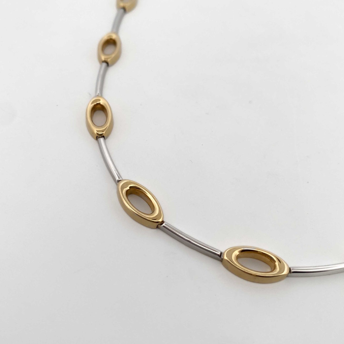 Comprar collar semirrígido realizado en oro blanco y amarillo de 18kt. Cierre de cajón y un brazo de seguridad. Joyería Compro Oro Barcelona. Ian'Or.