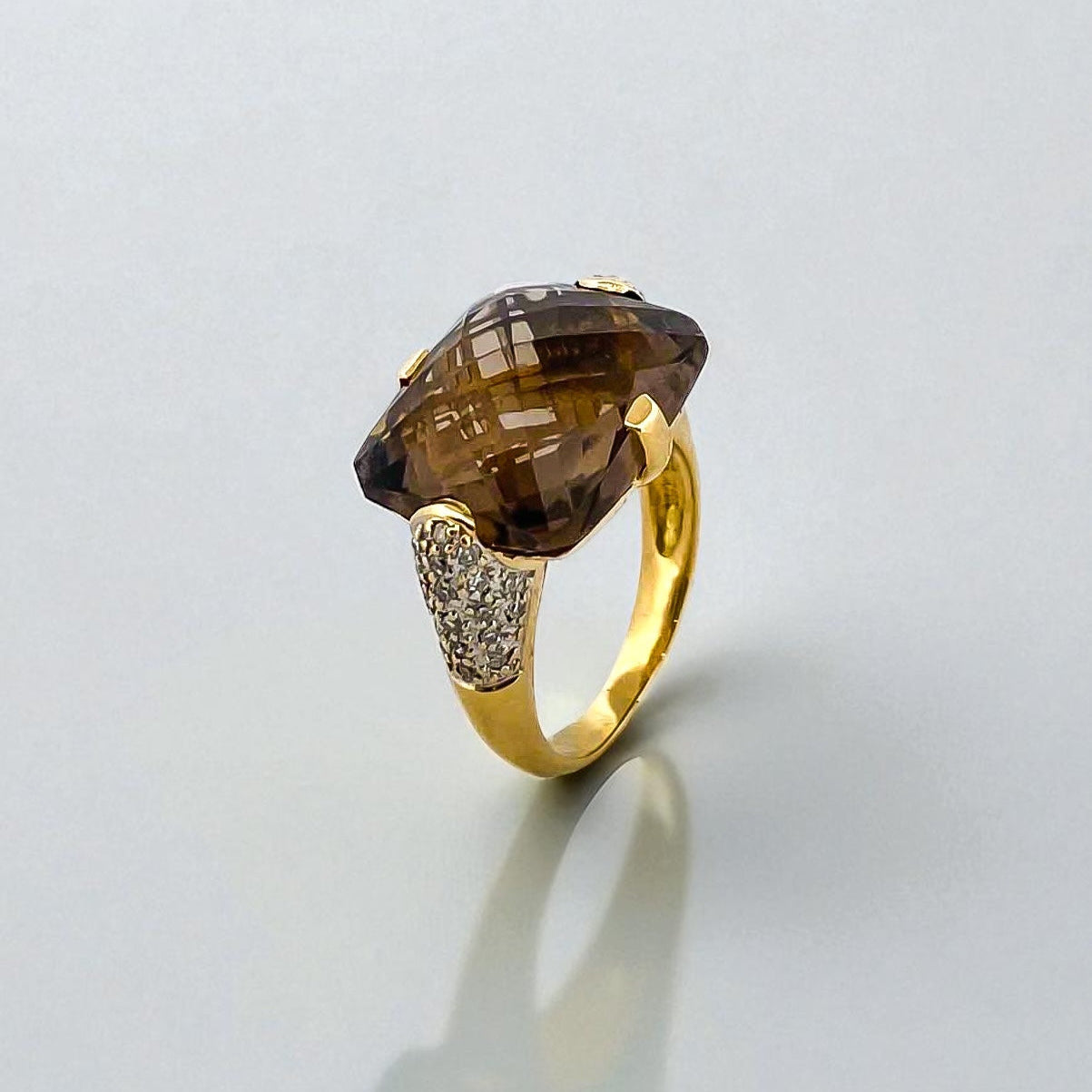 Comprar sortija de oro amarillo de 18kt con piedra central de color café y pavé de diamantes en los brazos. Joyería compro oro Ian'Or. Envío GRATIS.