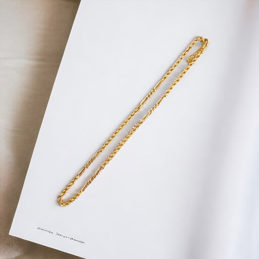 Collar de Oro amarillo de 18kt con cadena de cordón salomónico alterno con barras de oro de 18kt. La cadena mide 53cm de largo y dispone de un cierre tipo anzuelo con un cierre de seguridad.