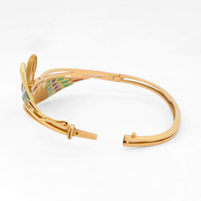 Espectacular pulsera de oro amarillo de 18kt tipo esclava con 2 cisnes que sujetan un diamante talla brillante. Joyas antiguas y vintage en Barcelona.