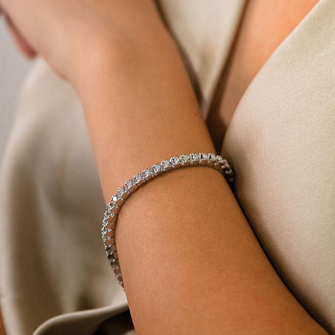 Pulsera Riviere de la firma TOUS realizada en oro blanco de 18kt con 46 diamantes talla brillante de 0,05 ct cada uno con engaste en tensión con detalles del icónico osito. Una preciosa joya con más de 2 quilates de diamantes. La pulsera mide 19cm y dispone de cierre de cajón
Joyas de segunda mano de firma. Joyas Tous restauradas al mejor precio, donde encontrar joyas baratas