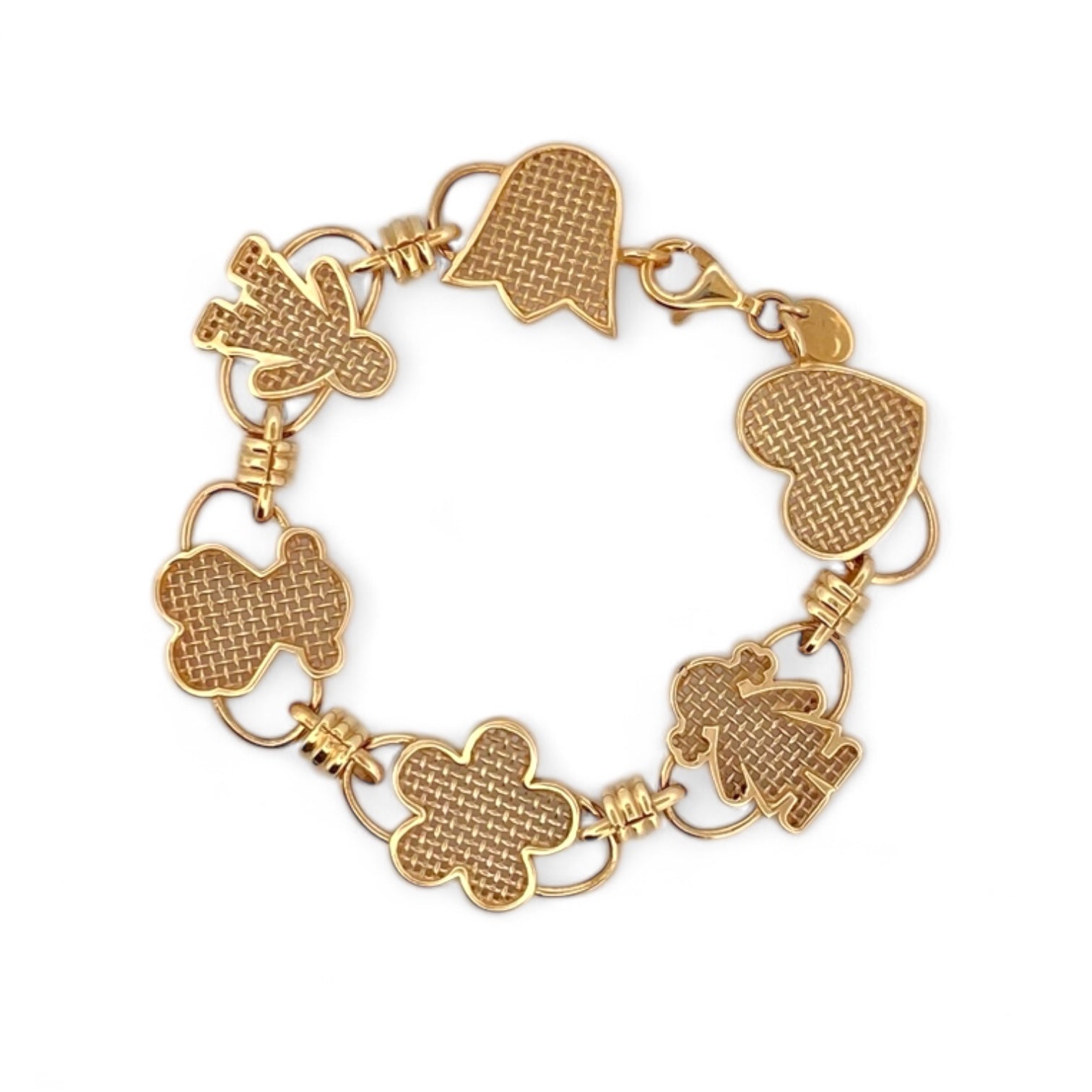 Pulsera original de Tous calada de Oro de 18kt y piezas con motivos de tulipán, osito flor, niña y corazón y cierre tipo mosquetón. La pulsera mide 17,8cm y las piezas 15,86mm. Esta pieza ha sido restaurada en nuestro taller de Barcelona. Compro Oro al mejor precio, joyería segunda mano Barcelona, diseño y transformación de joyas.