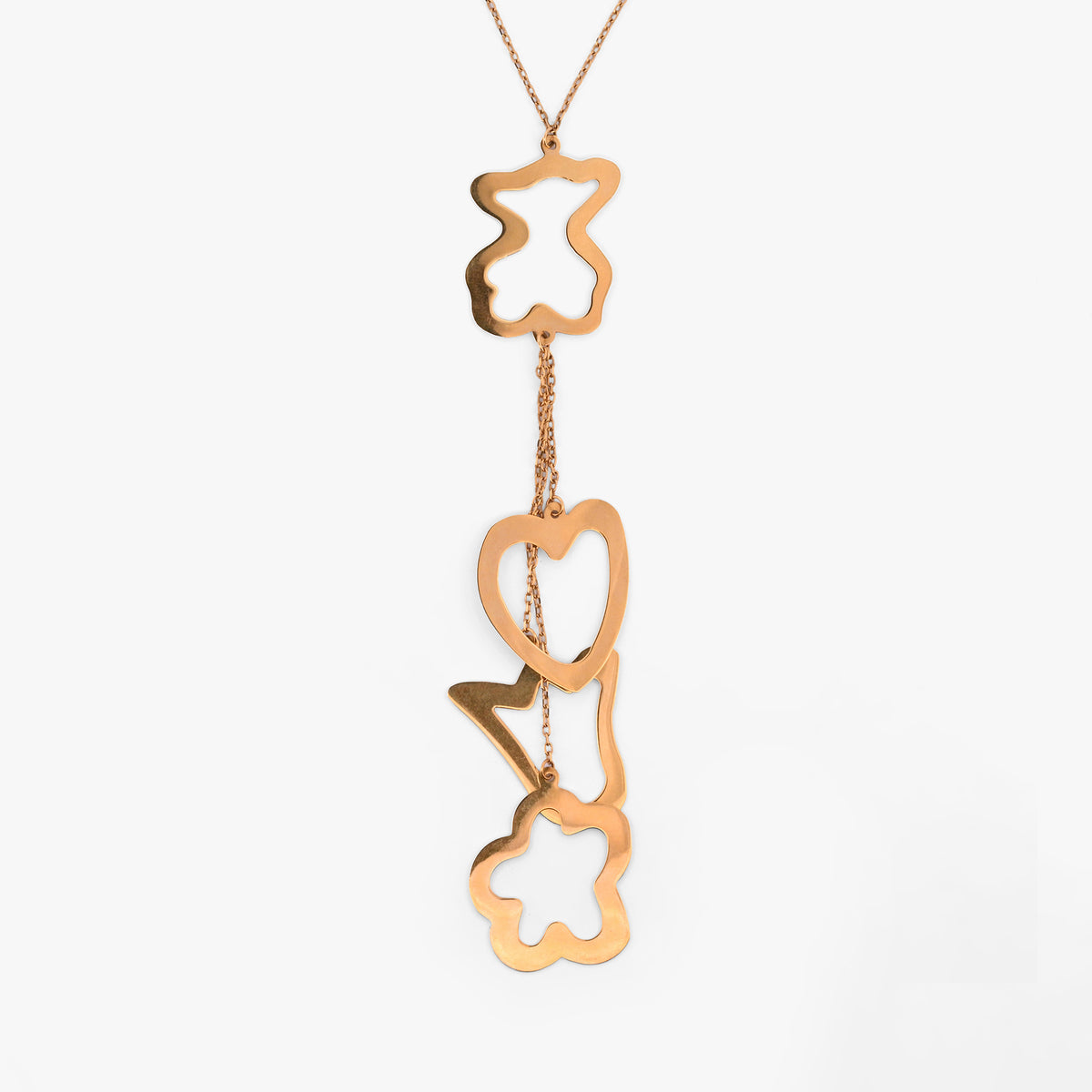 Collar original de la firma Tous de oro de 18kt con cadena de 40cm de largo y colgantes en forma de osito, corazón, tulipán y flor en oro. Con cierre tipo reasa.