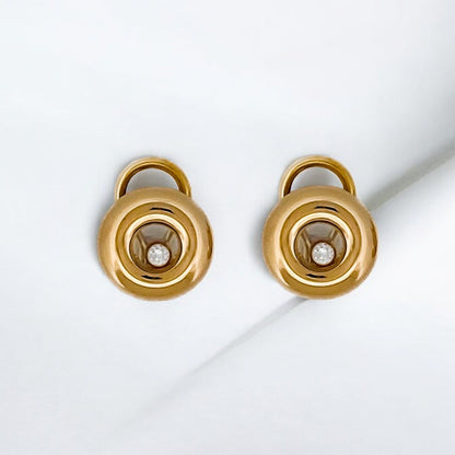 Pendientes en oro amarillo de 18kt de la prestigiosa firma Chopard. Modelo Happy diamonds icons. Dispone de 1 diamantes talla brillante en cada pendiente. Dónde comprar  y vender joyas al mejor precio en Barcelona. Envío gratuito. Joyas Chopard.