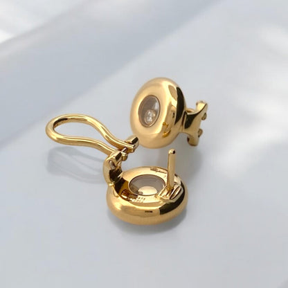 Pendientes en oro amarillo de 18kt de la prestigiosa firma Chopard. Modelo Happy diamonds icons. Dispone de 1 diamantes talla brillante en cada pendiente. Dónde comprar  y vender joyas al mejor precio en Barcelona. Envío gratuito. Joyas Chopard.