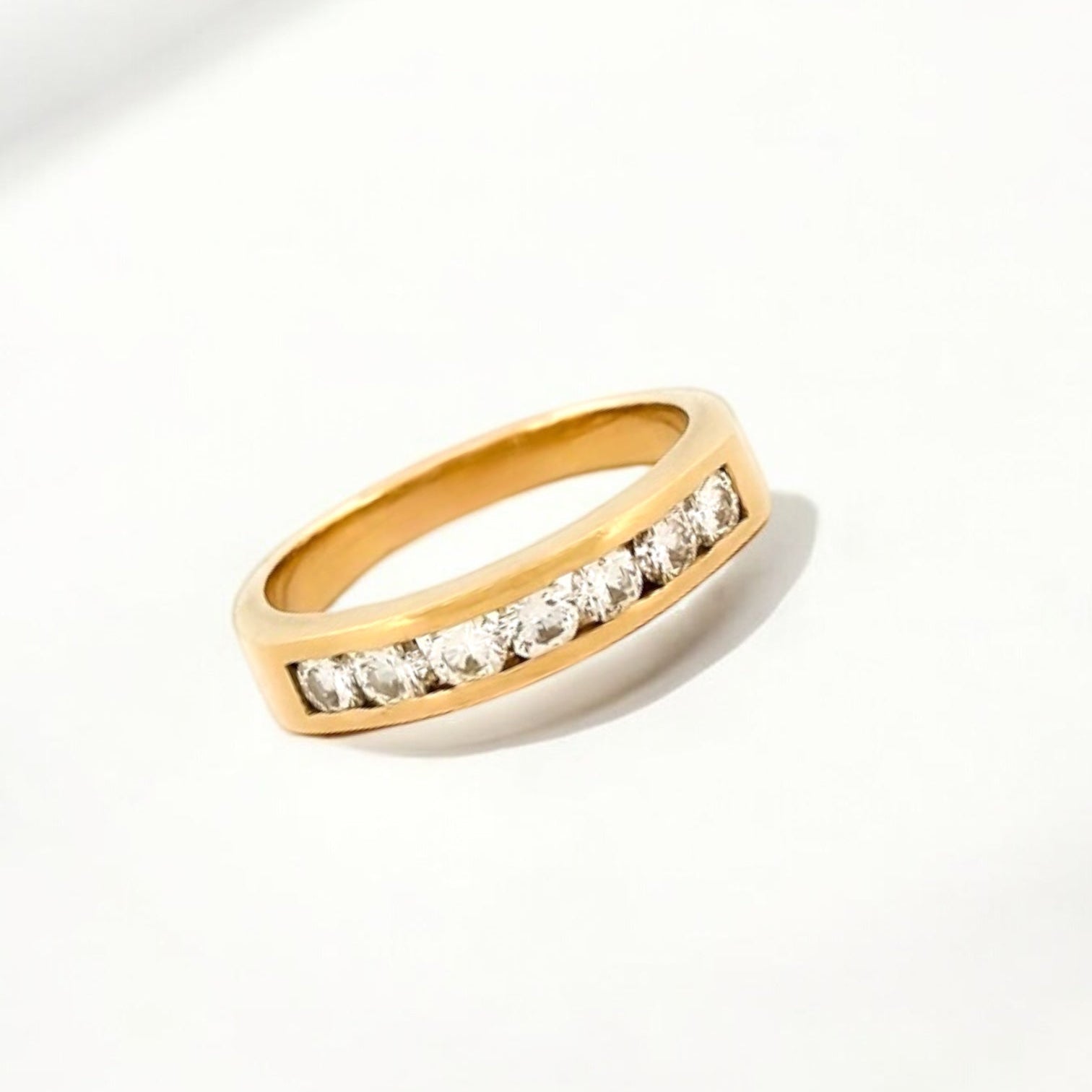 Media alianza de oro amarillo de 18kt con carril de 7 diamantes talla brillante de 0,10ct cada uno. Joyería compro oro, dónde comprar y vender joyas al mejor precio en Barcelona. Joyas de segunda mano  al mejor precio, envío gratuito. Anillos de compromiso baratos.