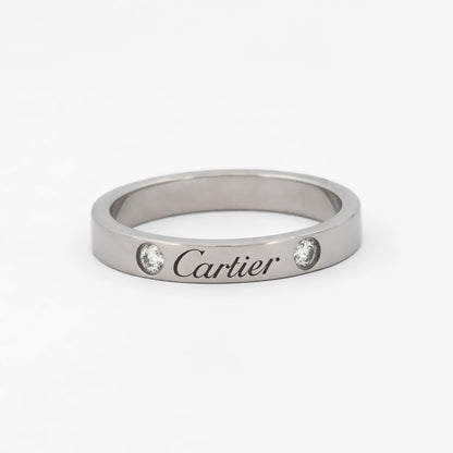 Comprar alianza de la prestigiosa firma Cartier realizada en platino y con dos diamantes talla brillante engastados. Cartier de segunda mano. Joyería Ian'Or.