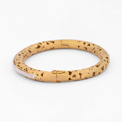 Comprar pulsera esclava de oro amarillo de 18kt en acabado mate y diseño de corazones con carril de oro blanco y 33 diamantes talla brillante. Joyería Ian'Or.