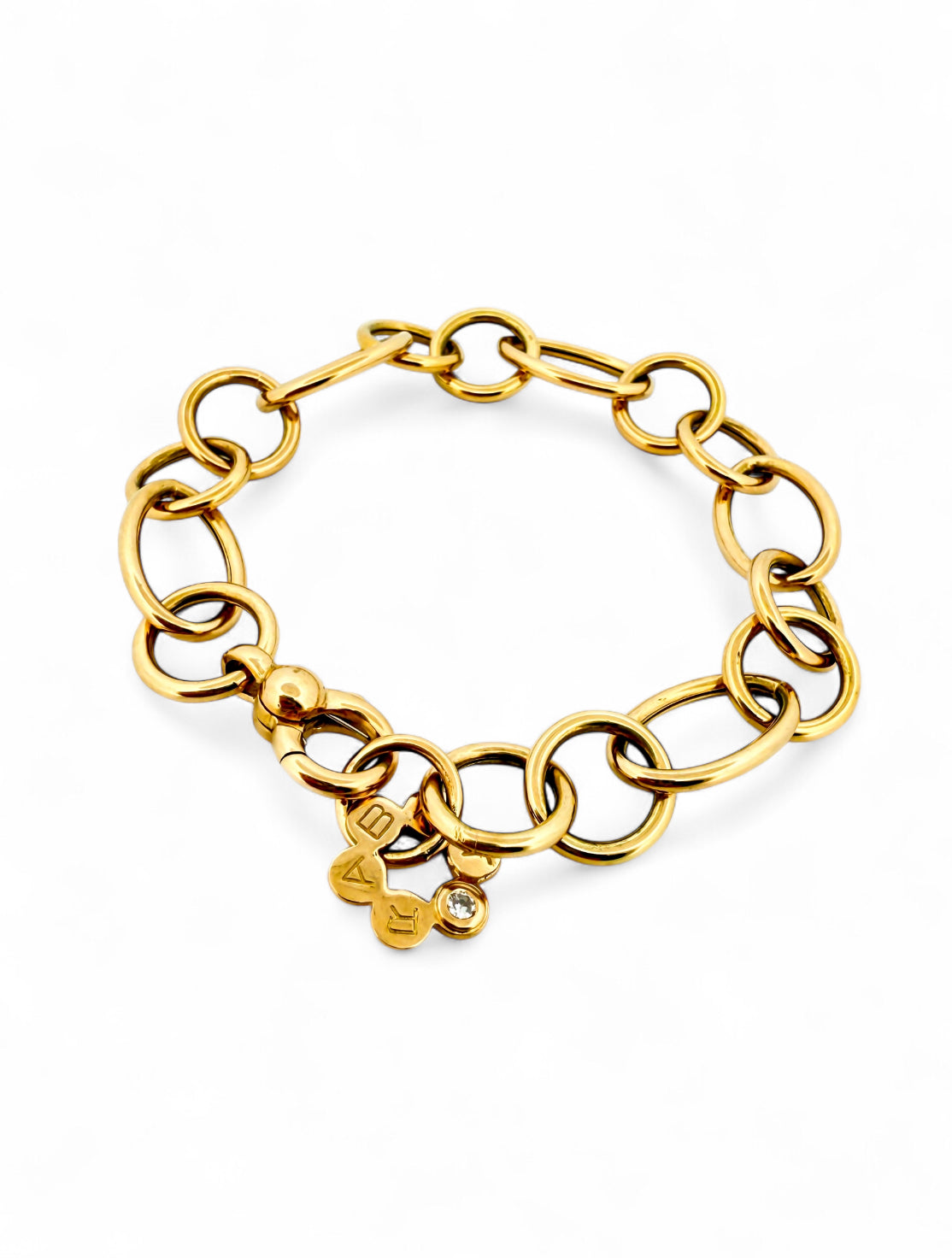 Pulsera original de la firma RABAT realizada de oro amarillo de 18kt y eslabones con forma circular de diferentes medidas intercaladas y flor con detalle de bri…

