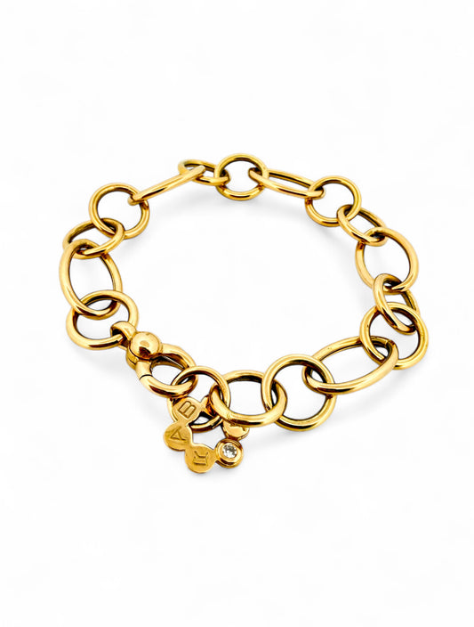 Pulsera original de la firma RABAT realizada de oro amarillo de 18kt y eslabones con forma circular de diferentes medidas intercaladas y flor con detalle de bri…

