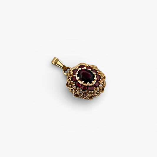 Comprar Colgante realizado en oro amarillo de 18kt con 10 granates, alrededor de un granate central. Joyería Barata en Barcelona.