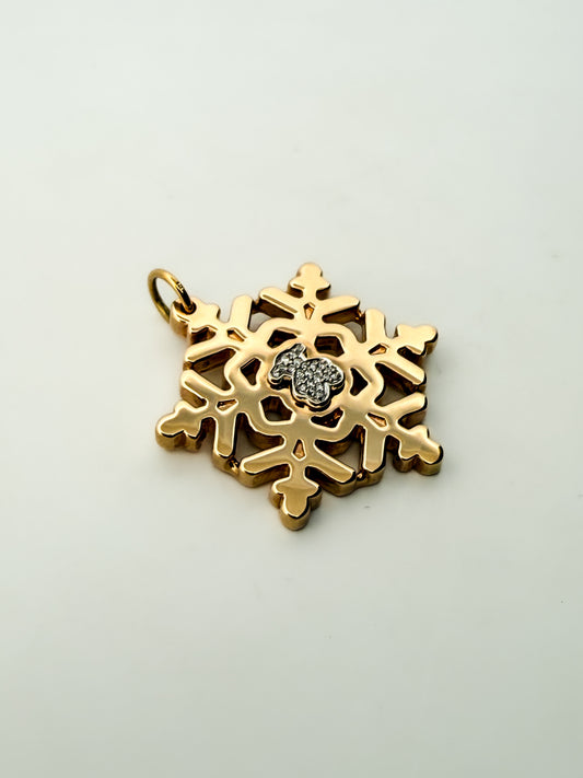 Colgante de la firma TOUS realizado en oro amarillo y blanco de 18kt en forma de copo de nieve y oso en la parte central con pavé de de diamantes. Joyas Tous.

