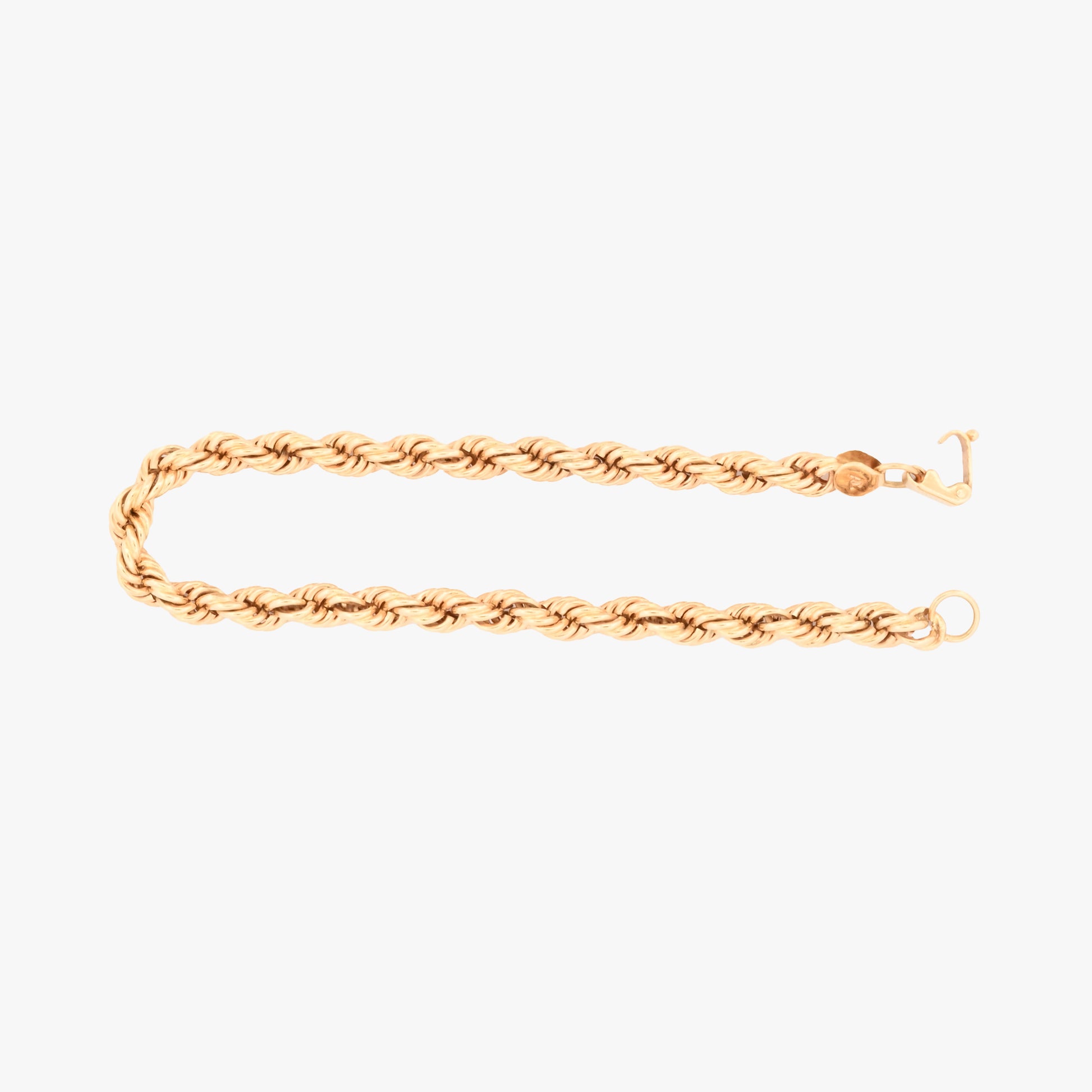 Comprar Pulsera de cordón de oro amarillo de 18kt de 19,5 cm de largo caracterizada por su diseño trenzado en espiral y un cierre de mosquetón. Pulseras de oro 18kt al mejor precio en Barcelona.