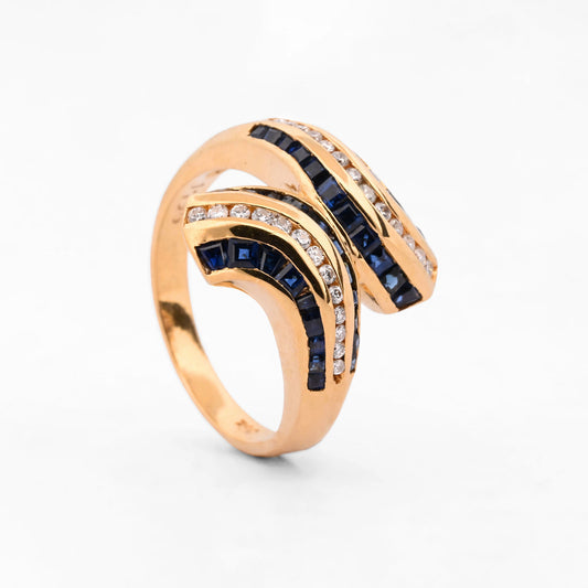 Comprar anillo de silueta cruzada en forma de S de oro amarillo 18kt con carriles combinados de zafiros azules. Pieza certificada y envío gratuito 