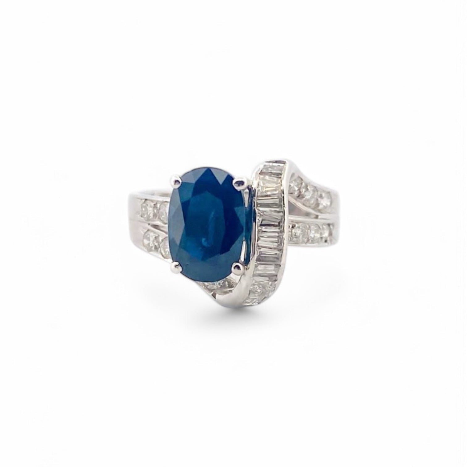 Anillo realizado en oro blanco de 18kt con un zafiro central talla oval engastado en 4 grapas y diamantes. Joyas de segunda mano Barcelona. Envío gratis.