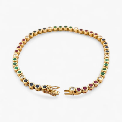 Pulsera semirígida de oro de 18kt con 3 rubíes, 3 esmeraldas y 30 zafiros azules talla princesa. Joyería Ian'Or. Joyas segunda vida. Envío GRATIS.