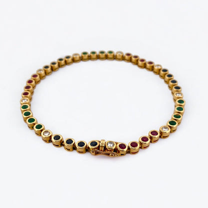 Pulsera semirígida de oro de 18kt con 3 rubíes, 3 esmeraldas y 30 zafiros azules talla princesa. Joyería Ian'Or. Joyas segunda vida. Envío GRATIS.