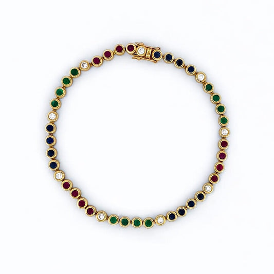 Pulsera semirígida de oro de 18kt con 3 rubíes, 3 esmeraldas y 30 zafiros azules talla princesa. Joyería Ian'Or. Joyas segunda vida. Envío GRATIS.