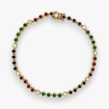 Pulsera semirígida de oro de 18kt con 3 rubíes, 3 esmeraldas y 30 zafiros azules talla princesa. Joyería Ian'Or. Joyas segunda vida. Envío GRATIS.