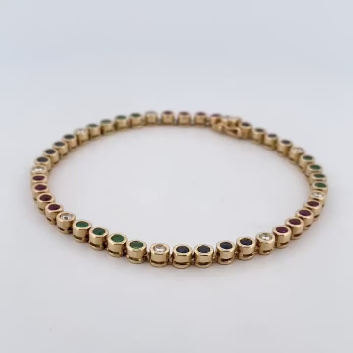 Pulsera semirígida de oro de 18kt con 3 rubíes, 3 esmeraldas y 30 zafiros azules talla princesa. Joyería Ian'Or. Joyas segunda vida. Envío GRATIS.